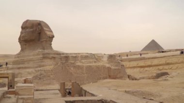 Giza , Egypt . Great Sphinx on the west bank of the Nile in Giza . In the background Pyramid of Menkaure