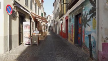 Madeira Portekiz 'deki dar sokakların duvarlarında sokak resimleri var.