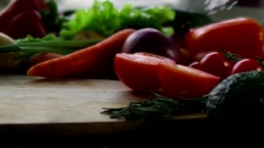 Masanın üzerine taze sebzeler serpiştirilmiş kaya tuzu serpin.