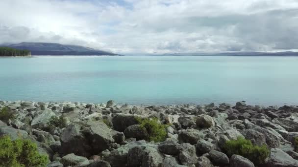 Rochas de diferentes formas e tamanhos na margem do lago — Vídeo de Stock