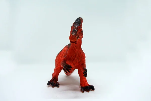 2 leg toys dinosaur in red color and made of plastic isolated in white background.