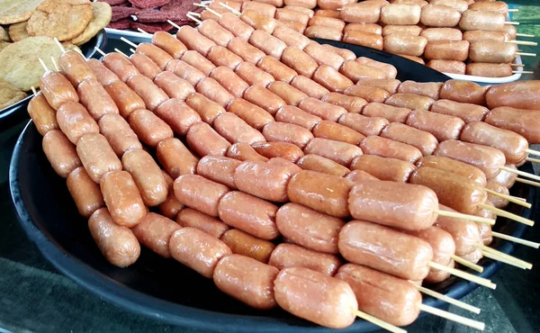Sausages and other processed foods are packed with skewers and served on the table. Sell by street hawkers in the market.