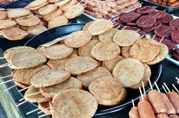 Sausages and other processed foods are packed with skewers and served on the table. Sell by street hawkers in the market.