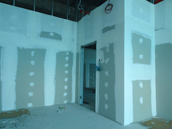 KUALA LUMPUR, MALAYSIA -APRIL 12, 2018: Drywall installation work in progress by construction workers at the construction site. It is the easiest and cheapest way to do partition for an interior wall. 