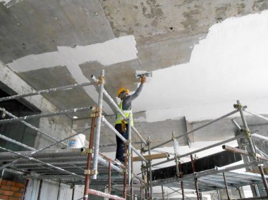 Kuala Lumpur, Malezya-06 Nisan 2017: inşaat site işçileri tavan recessed yağsız kat işini inşaat sahasında yapıyorsunuz. İki katmanlar temel ve son kat uygulayın düzgün yüzey elde etmek için. 