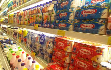 KUALA LUMPUR, MALAYSIA -MARCH 16, 2018: Milk containing prebiotic and good bacteria packed in small bottles and displayed on shelves in the supermarket for sale. clipart