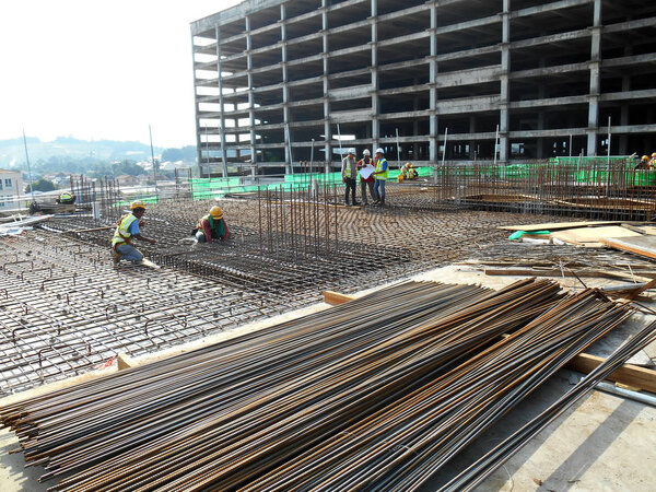 KUALA LUMPUR, MALAYSIA -JUNE 7, 2018: Construction workers installing reinforcement bar at the construction site. Reinforcement bar is the main component for the reinforcement concrete. 