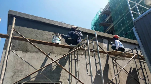 クアラルンプール マレーシア 2018 セメント石膏を使用して建設労働者によって埋め尽くされてレンガの壁 足場の高さで仕事を一時ステージングとして使用します 起こる不良を防ぐために適切な安全ギヤを身に着けています — ストック写真