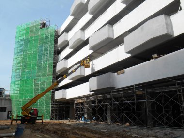Kuala Lumpur, Malezya-15 Haziran 2017: inşaat işçileri Mobil vinç ayakta kova inşaat alanı içinde yüksek düzeyde çalışırken. Kova hareket işçiler tarafından kendini kontrol.  