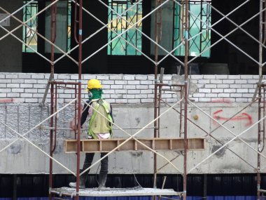 Kuala Lumpur, Malezya-10 Ağustos 2017: inşaat işçileri yükseklikte inşaat alanında çalışıyor. Onlar kötü olur etmelerini önlemek için uygun güvenlik dişli giymek için rica olunur. 