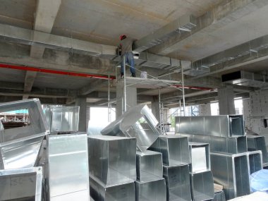 KUALA LUMPUR, MALAYSIA - SEPTEMBER 16, 2017: Air-condition and ventilation duct installed by construction workers  at the construction site. Distribute cool air and control the temperature.   clipart