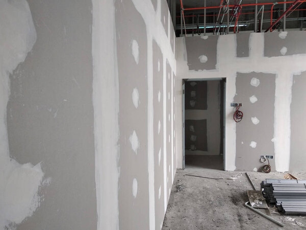 KUALA LUMPUR, MALAYSIA -MARCH 29, 2018: Drywall installation work in progress by construction workers at the construction site. It is the easiest and cheapest way to do partition for an interior wall. 