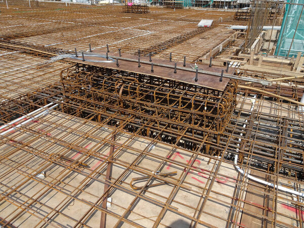 Reinforcement bar tied together using tiny wire and place on top or inside the plywood form work before pouring the concrete.     