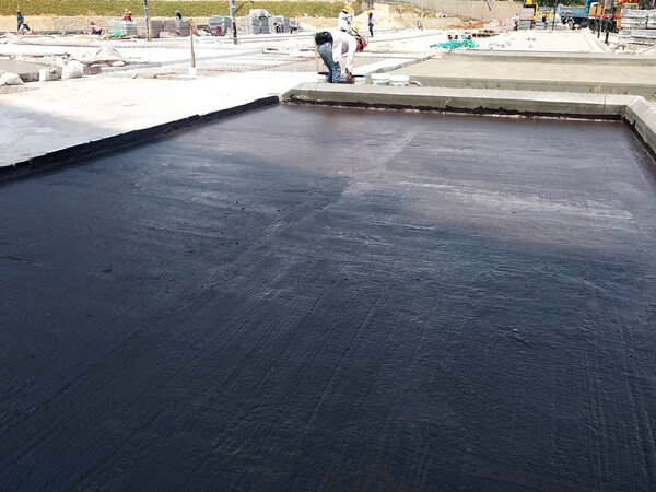KUALA LUMPUR, MALAYSIA -SEPTEMBER 18, 2018: Waterproof coatings applied on flat roof concrete surfaces. There are several layers and layers of fiber mesh added to strengthen the bonding of the waterproofing layer. 