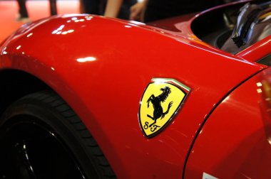 KUALA LUMPUR, MALAYSIA - NOVEMBER 24, 2018: Ferrari car brand emblem and logos. Ferrari is an Italian luxury sports car manufacturer based in Maranello. clipart