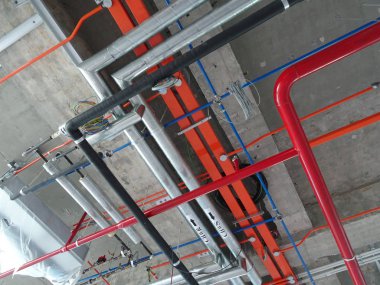 KUALA LUMPUR, MALAYSIA -JUNE 18: 2018: Chiller pipes and other services pipes ducting and trunking installed above ceiling level at the construction site.   clipart
