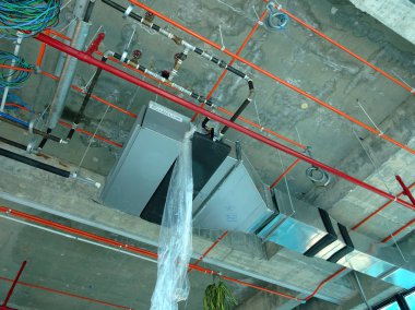 KUALA LUMPUR, MALAYSIA -JUNE 18: 2018: Chiller pipes and other services pipes ducting and trunking installed above ceiling level at the construction site.   clipart