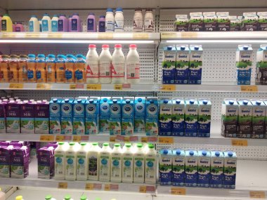 KUALA LUMPUR, MALAYSIA -MARCH 7, 2018: Selected focused on the dairy product displayed on cool chiller rack in the supermarkets. The product packed nicely following its brands.   clipart