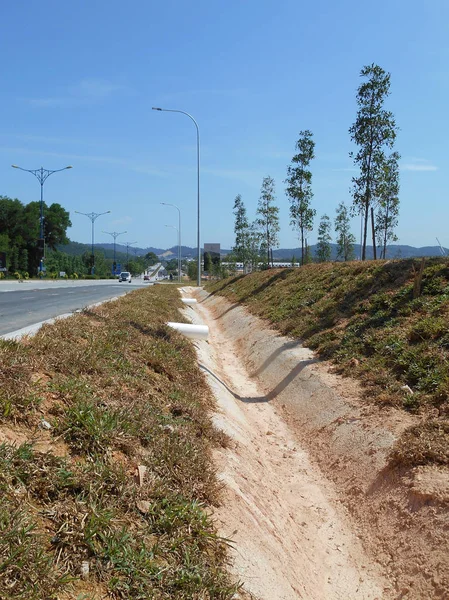 Cast-in-situ roadside drain used to channel rainwater from street to the monsoon drain or bigger drain.