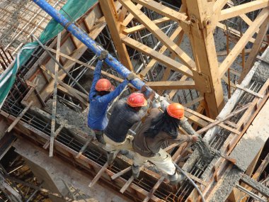 Kuala Lumpur, Malezya -16 Ocak 2018: İnşaat işçileri beton örümcek hortumu kullanarak beton beton dökerek şantiyede levha formunda çalışma yaptı. 