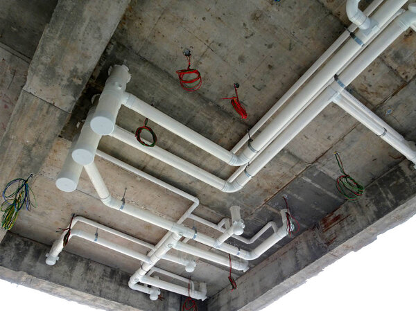 KUALA LUMPUR, MALAYSIA -JANUARY 15, 2018: UPVC sewerage pipe below toilet's soffit under construction at the construction site. The pipes connected together and channels to the main sewer. 