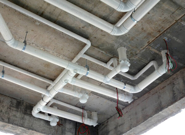 KUALA LUMPUR, MALAYSIA -JANUARY 15, 2018: UPVC sewerage pipe below toilet's soffit under construction at the construction site. The pipes connected together and channels to the main sewer. 