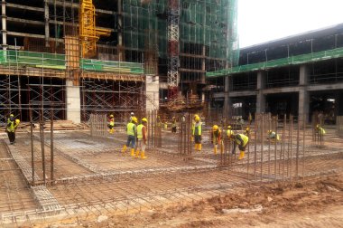 Kuala Lumpur, Malezya -16 Temmuz 2017: Büyük şantiyede çalışan inşaat işçileri. Kazanın olmasını önlemek için uygun güvenlik donanımı takmak. 