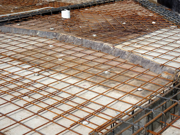 KUALA LUMPUR, MALAYSIA -FEBRUARY 16, 2018: Steel reinforcement bar and timber formworks at the construction site. Be part of the reinforced concrete structure. It is tied together using tiny wire before pouring the concrete.      