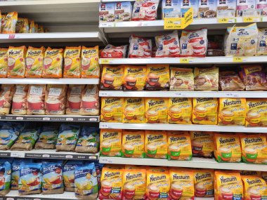 KUALA LUMPUR, MALAYSIA - SEPTEMBER 28, 2019: Cereal food packed in the paper box and plastic package. Displayed on the rack in huge supermarkets.  clipart
