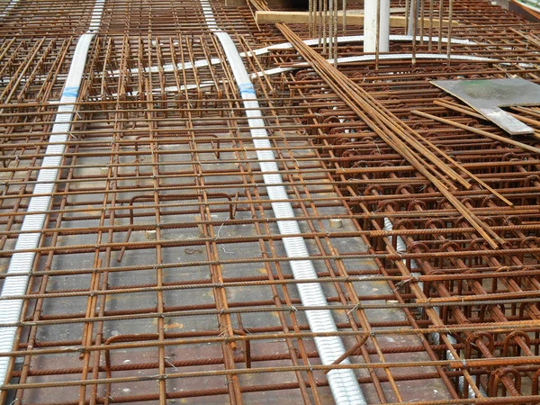 Hot-rolled deformed steel bars or steel reinforcement bar tied together before casting in the concrete. Its function is to increase the concrete strength.