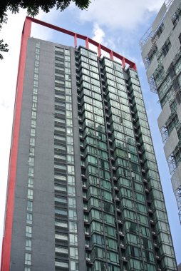 KUALA LUMPUR, MALAYSIA - 16 Haziran 2016: Doğrudan güneş ışığının binaya girmesini önlemek için güneş gölgesi cihazlarıyla yüksek binalar inşa etme cephesi. 