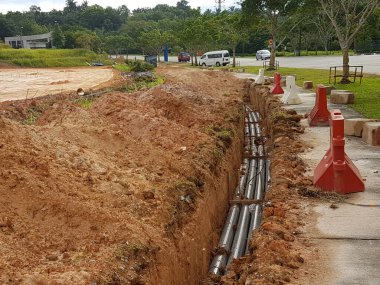 SEREMBAN, MALAYSIA -AĞUSTOS 01, 2019: İnşaat alanındaki siperlere işçiler tarafından döşenmiş yeraltı hizmet borusu. Boruların kurulumu devam ediyor.    
