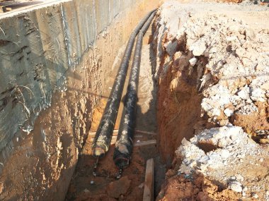 SEREMBAN, MALAYSIA -AĞUSTOS 01, 2019: İnşaat alanındaki siperlere işçiler tarafından döşenmiş yeraltı hizmet borusu. Boruların kurulumu devam ediyor.    