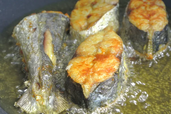 Spanish mackerels fish cut into thick slices and fried using hot cooking oil. The slices of fish were previously sprinkled with turmeric powder to add flavour.