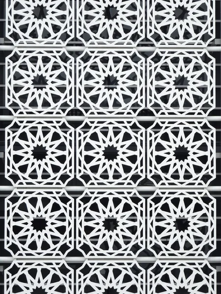 Islamic geometry pattern made from metals and ground fibre reinforcement concrete used as building facade as wall decoration.