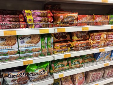 KUALA LUMPUR, MALAYSIA -JUNE 01, 2020: Variety of biscuits in good and interesting packaging and displayed on the racks inside the shop. Sort by brand and type to make it easier for customers to buy. clipart
