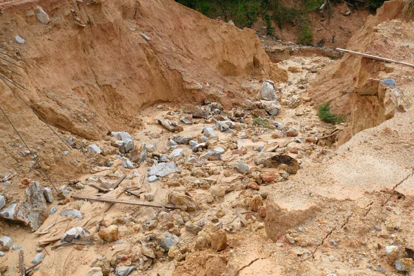 Erosion at ground and slopes is caused by rainfall. The soil structure is weak and there is a landslide. Safety measure has been taken in some area.