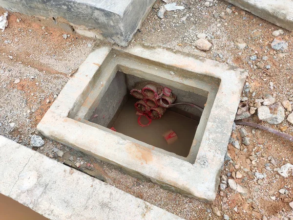 SEREMBAN, MALAYSIA -AUGUST 6, 2020: Utility services manhole and underground pipes under construction at the construction site. In-situ construction by workers based on infrastructure engineer design. — Stock Image Seremban Malaysia August 2020 Utility Services Manhole Underground Pipes Construction Stock Image