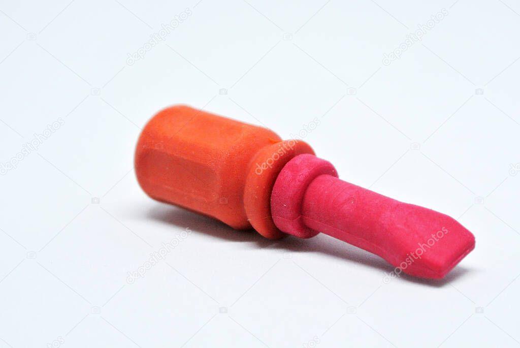 Selective focused, an image of toy screwdriver made from red and orange rubber isolated on white background.