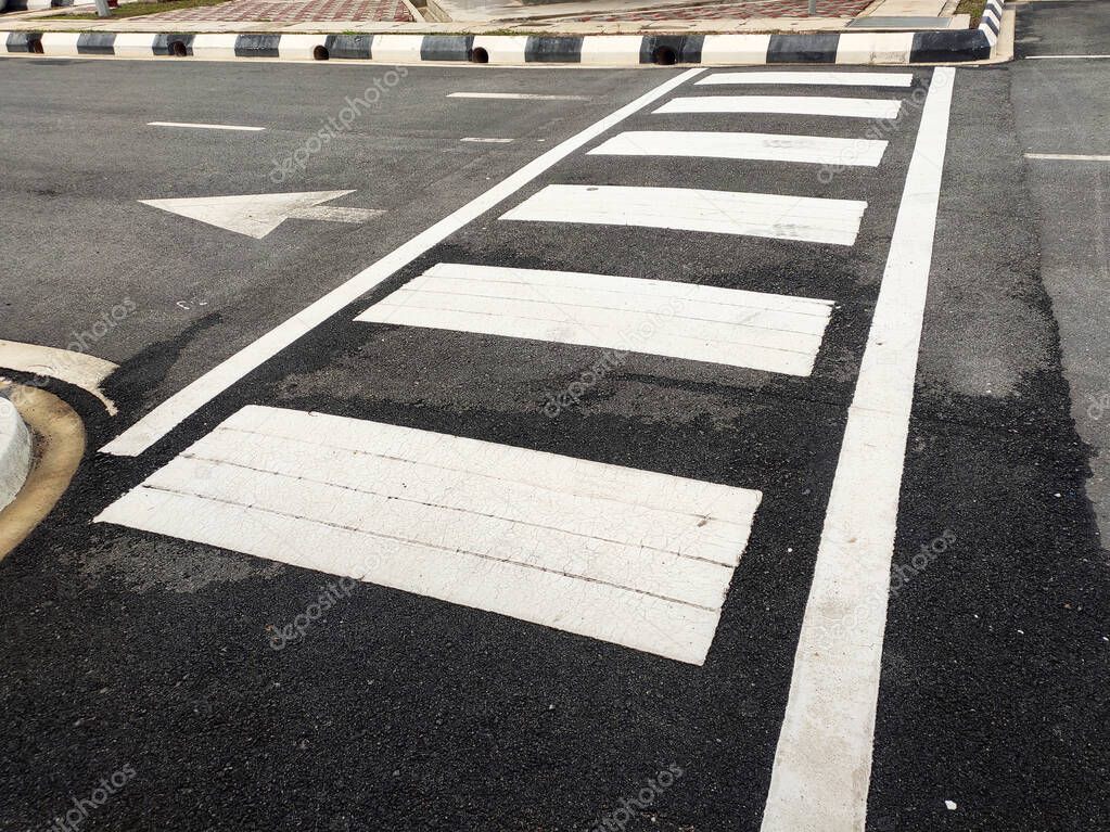 Zebra crossing for pedestrians on the road. Made of thermoplastic material and has light-reflective particles. Provides safety advantages to pedestrians.