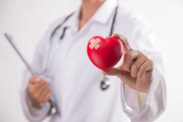 Woman holding red heart symbol of World heart day. White background isolated.