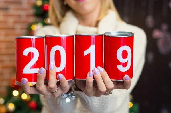 Girl holding a red can with 2019 digits