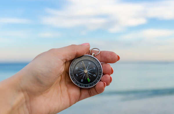 Girl holding a comass on the Odesa sea background