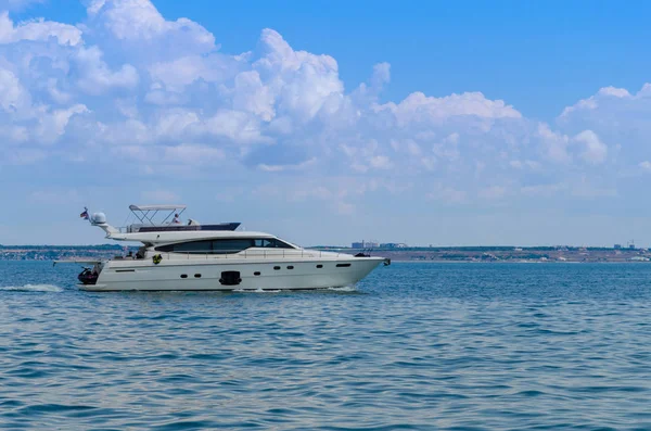 Small yacht in motion on the sea during the summer season