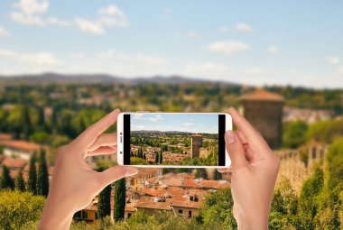 Bir turist bir cep telefonuna Floransa yakınındaki Toskana Peyzaj fotoğraf çekme