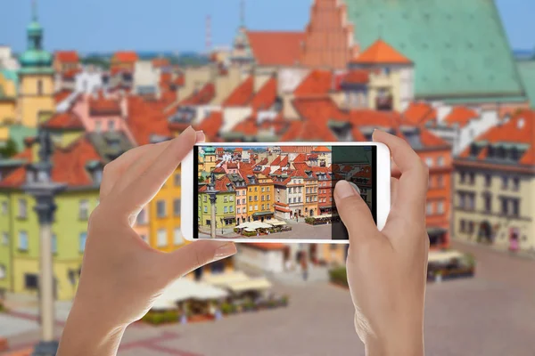 A man shooting a photo of old town in Warsaw