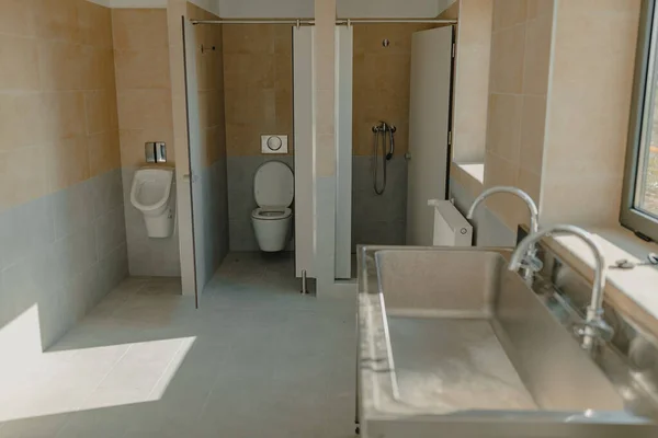 Industrial bathroom in a workshop, sink, shower and toilet