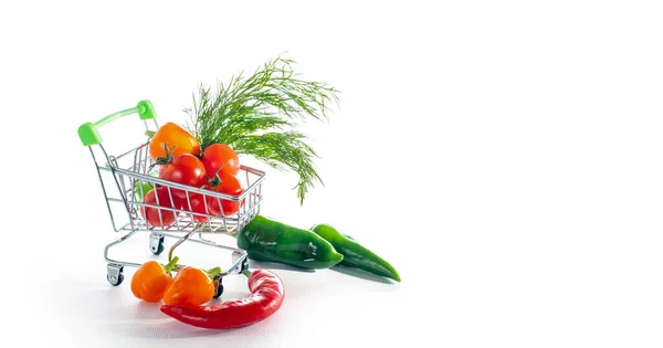 Toy shop trolley with fresh vegetables and greens on a white background, isolate, banner, copy space