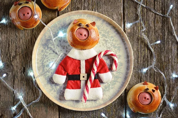 Cute Santa pig buns with sausages - symbol of 2019, the idea for children\'s breakfast.