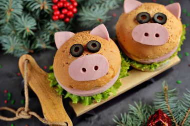 Sandviç bir jambon, peynir ve şirin bir domuz - 2019 sembolü şeklinde bir marul. Çocuk kahvaltı. Noel arka plan.